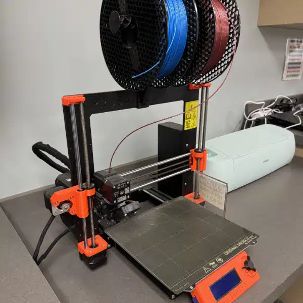 A 3d printer with red and blue filament