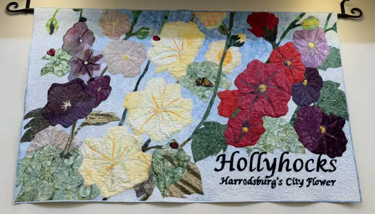 Handmade "Hollyhocks" quilt hangs in Mercer County Public LIbrary